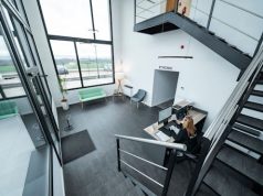 Tips for Transitioning Your Business Away From eFax A woman working at a stylish office desk, surrounded by modern tools showing a professional space