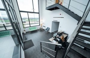 Tips for Transitioning Your Business Away From eFax A woman working at a stylish office desk, surrounded by modern tools showing a professional space