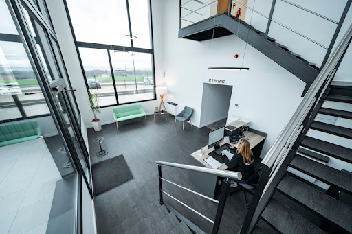 unnamed (10) A woman working at a stylish office desk, surrounded by modern tools showing a professional space