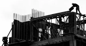 How Small Teams Can Use the NIST AI Risk Management Framework to Stay Ahead of AI Risk Illustration of a small team collaborating on AI risk assessment for sustainable building design using NIST framework guidelines