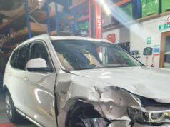 The Environmental Role of Modern Car Breakers Front-end damaged white BMW SUV inside a car breakers dismantling facility
